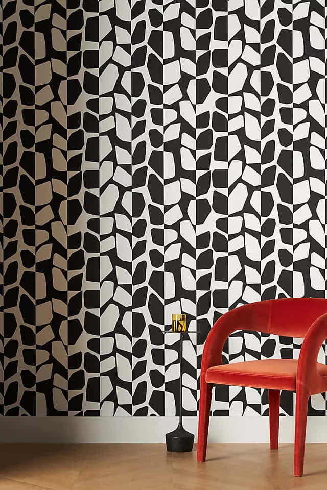 Eineschwarz-weiße Tapete Mit Einem Roten Stuhl. Wallpaper