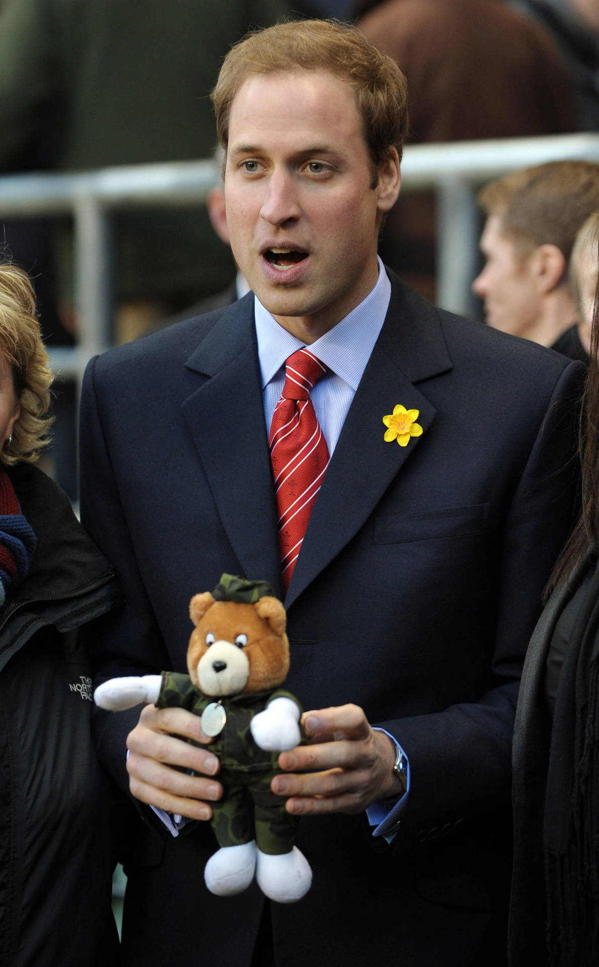 Prince William smiling while holding a stuffed toy Wallpaper