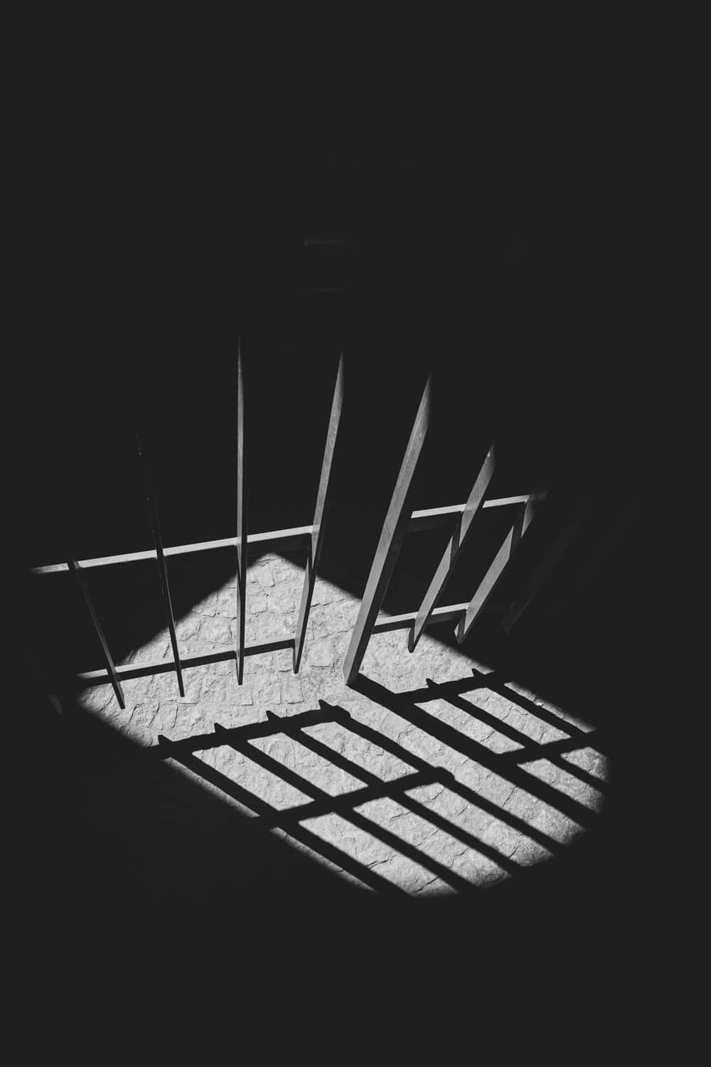 A Black And White Photo Of A Prison Cell