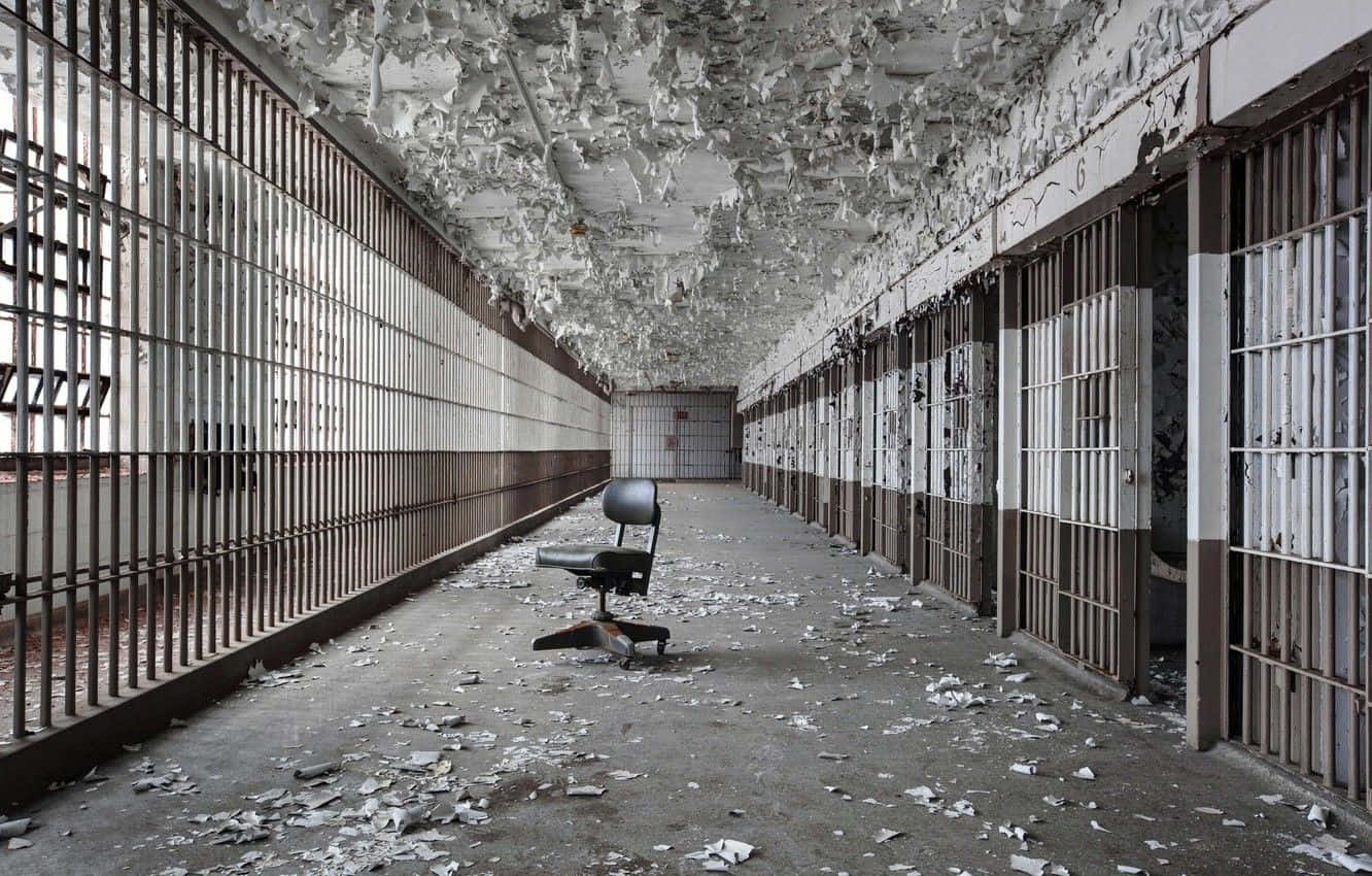 A Prison Cell With A Chair And A Chair