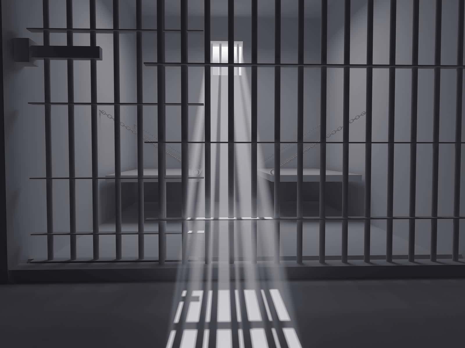 Unacelda De Prisión Con Luz Pasando A Través De Los Barrotes
