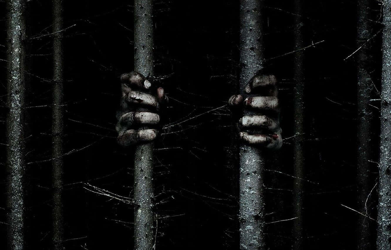The Hands Of A Zombie Hanging Out Of A Cage