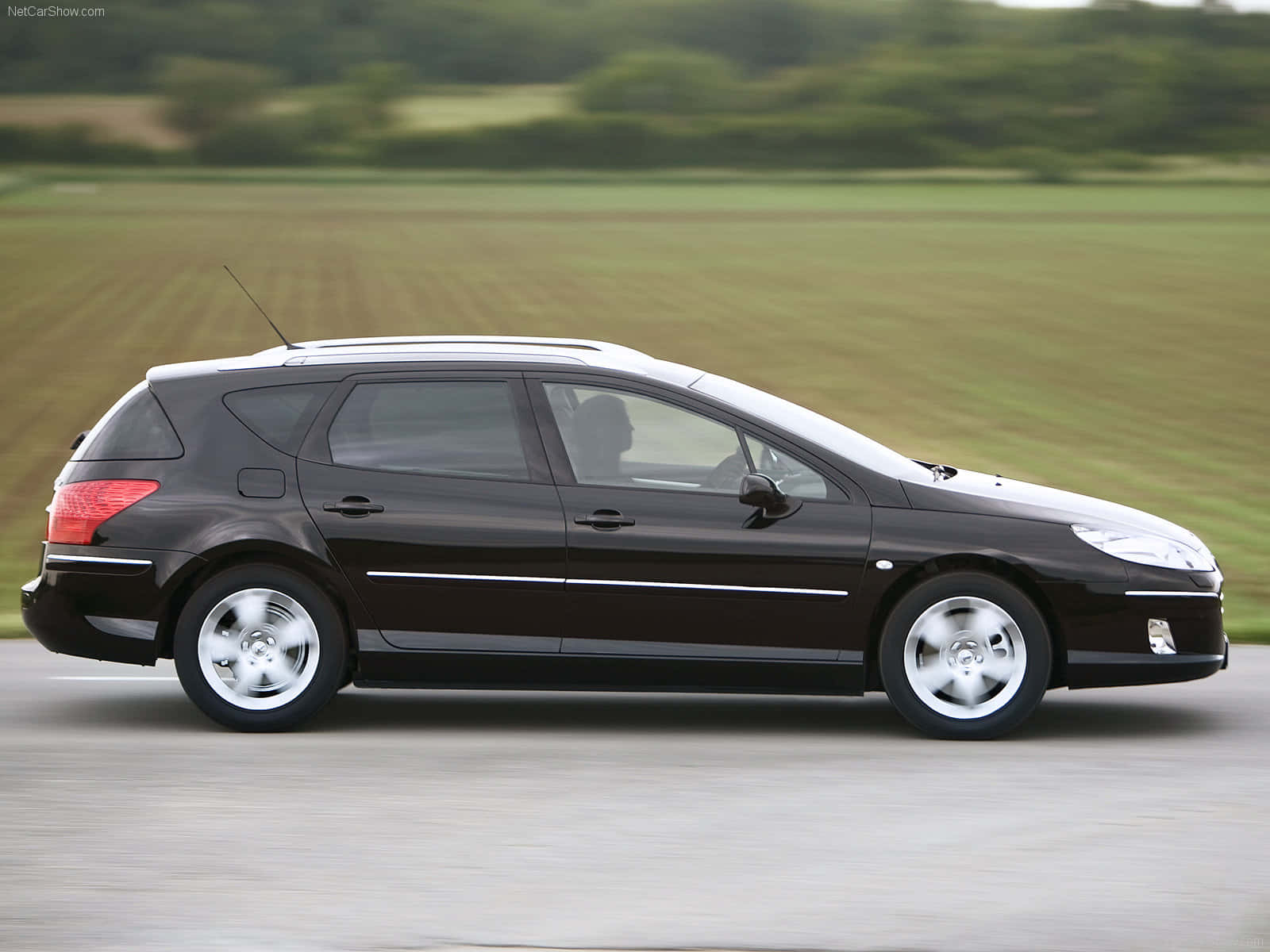 Pristine Peugeot 407 Cruising On The Open Highway Wallpaper