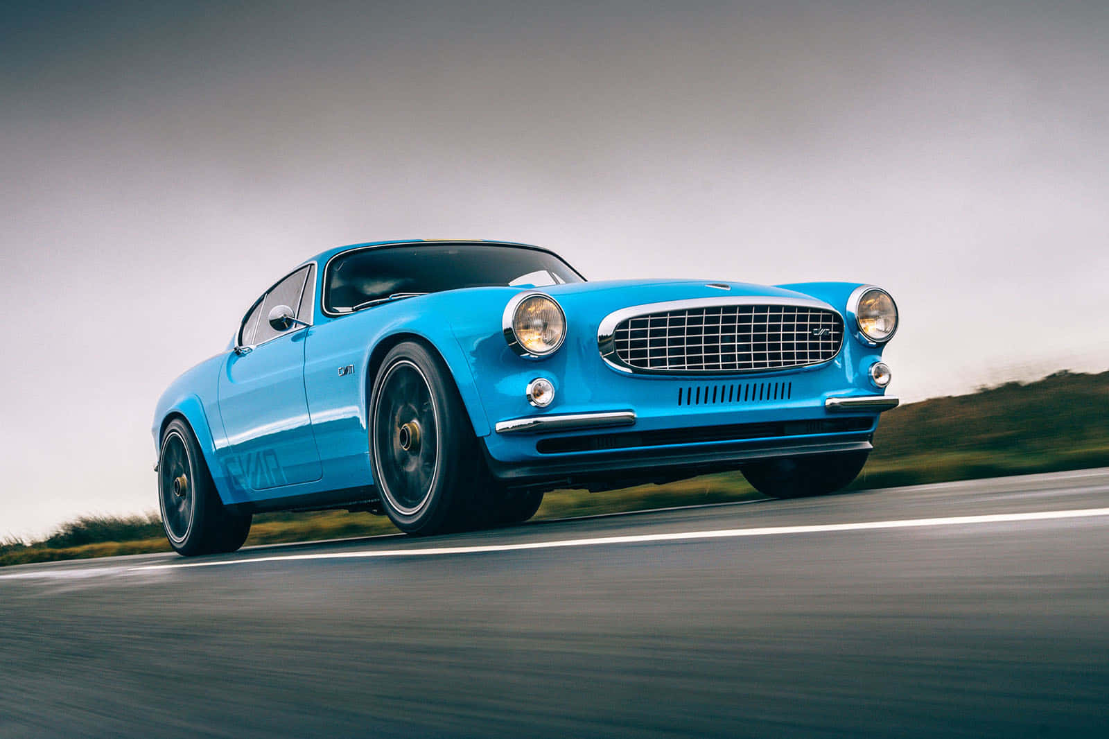 Pristine Vintage Volvo P1800 Coupe On Open Street Wallpaper