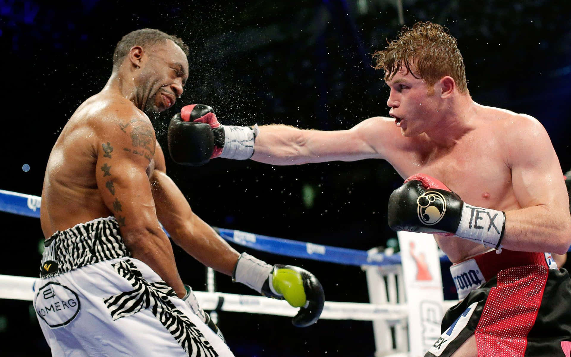 Professional Boxer Saul Canelo Alvarez Delivering A Powerful Punch During A Match Wallpaper