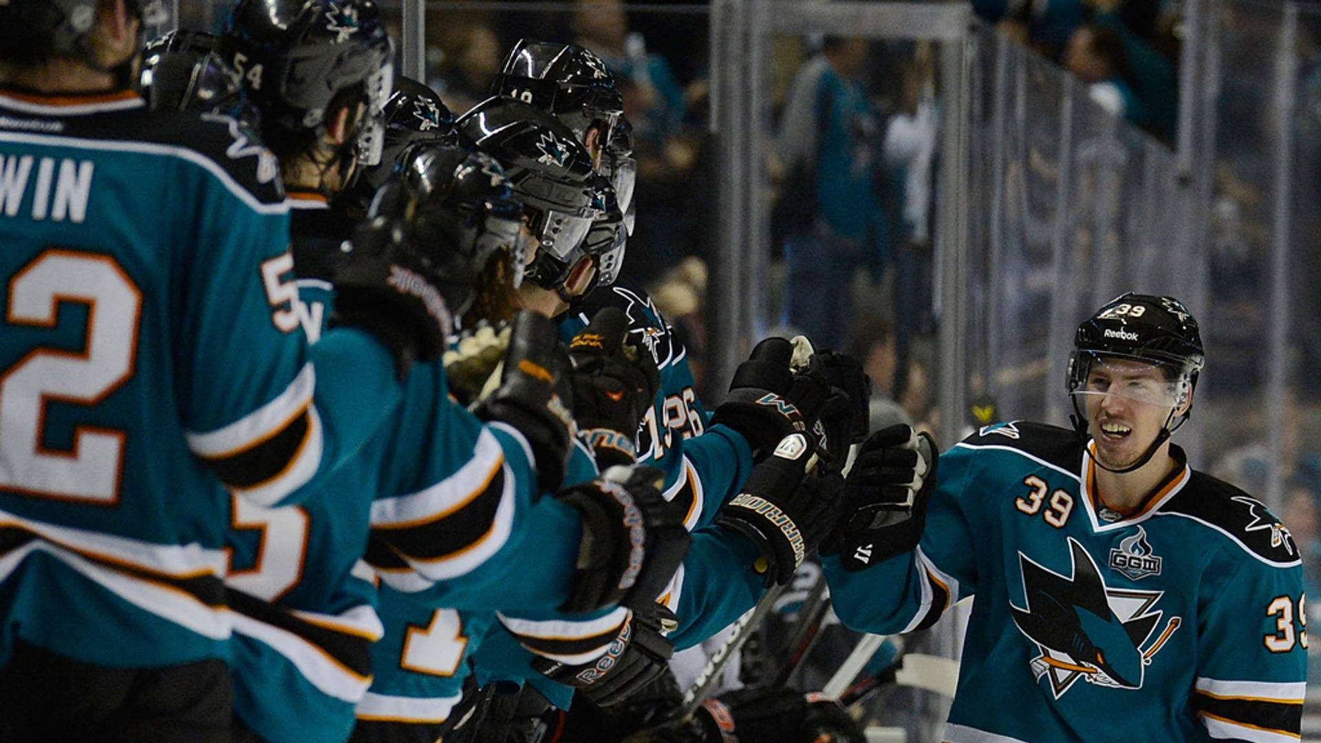 Logan Couture, professional ice hockey player, celebrating a great play with a fist bump to his teammates. Wallpaper
