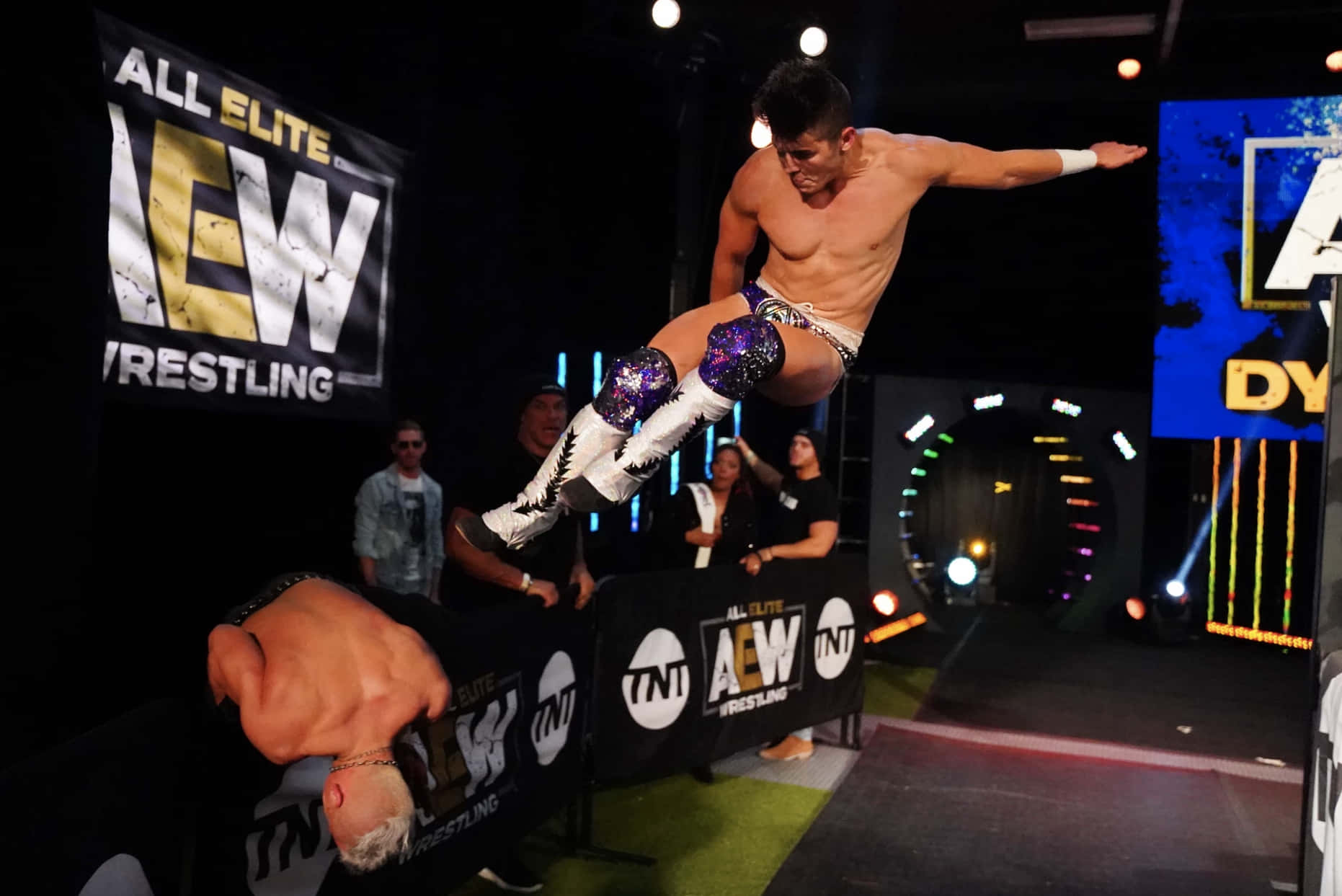 Professional Wrestler Sammy Guevara Kicking His Opponent Wallpaper