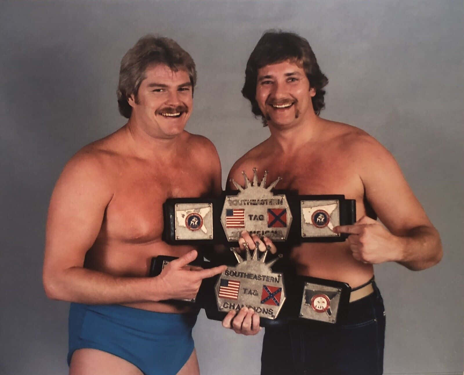 Professional Wrestlers Robert Fuller And Jimmy Golden With Belts Wallpaper