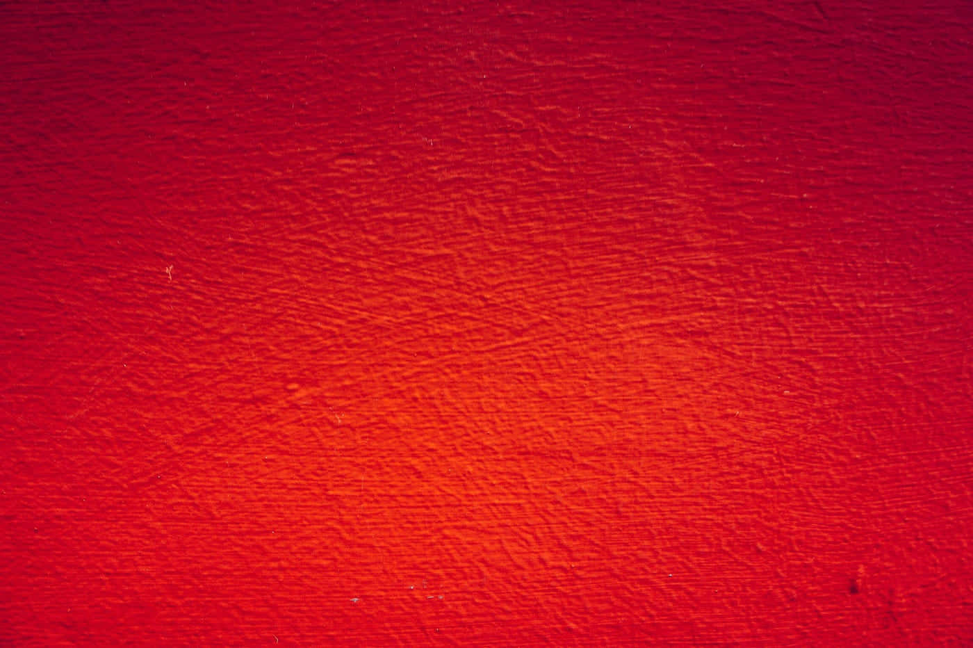 A Red Wall With A Paint Brush