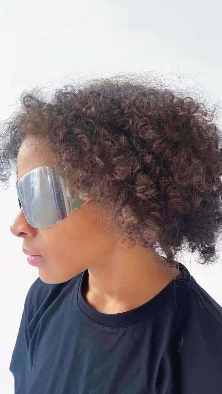 Profileof Womanwith Curly Hairand Sunglasses Wallpaper