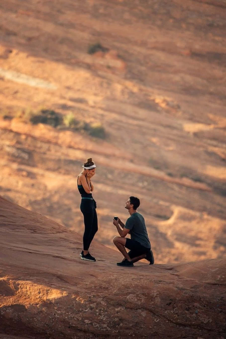 A romantic moment of proposing in front of a beautiful beach