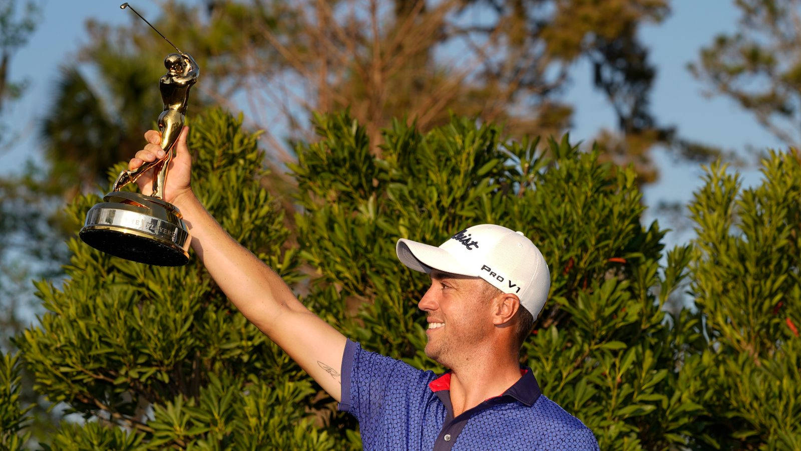 Triumph Personified: Justin Thomas Hoists Victory Trophy Wallpaper