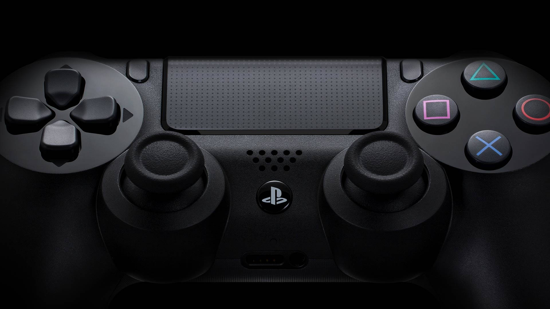 PS4 controller buttons up close black desktop wallpaper.