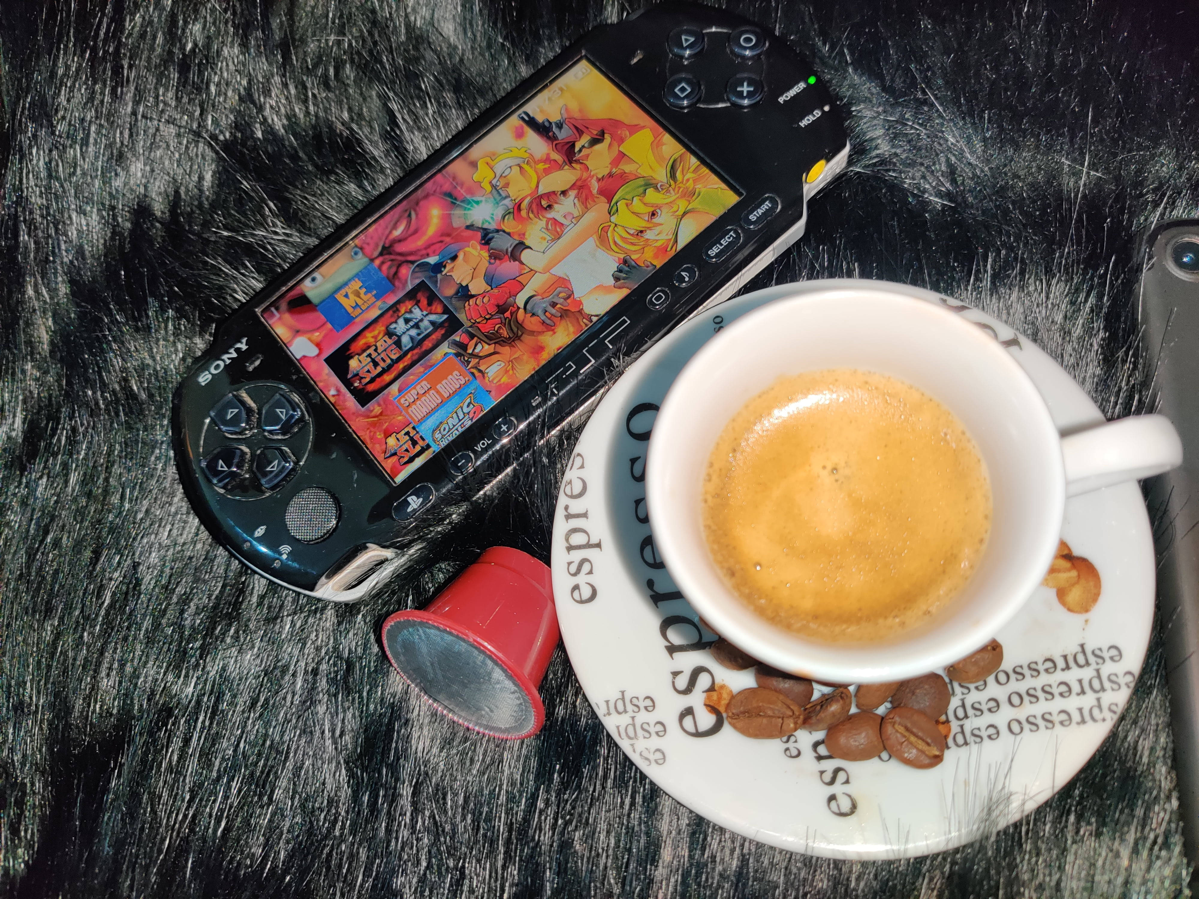 Psp With Coffee Cup On Fluffy Surface Wallpaper