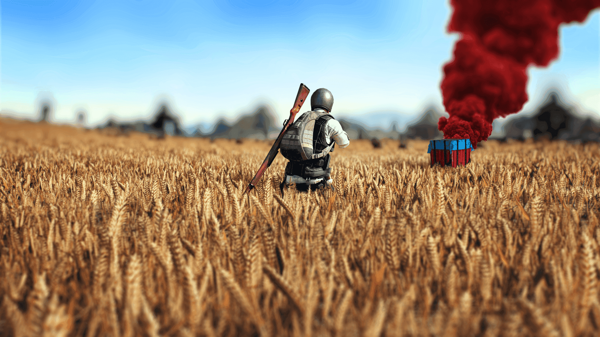 A Man Is Standing In A Field With A Red Fire