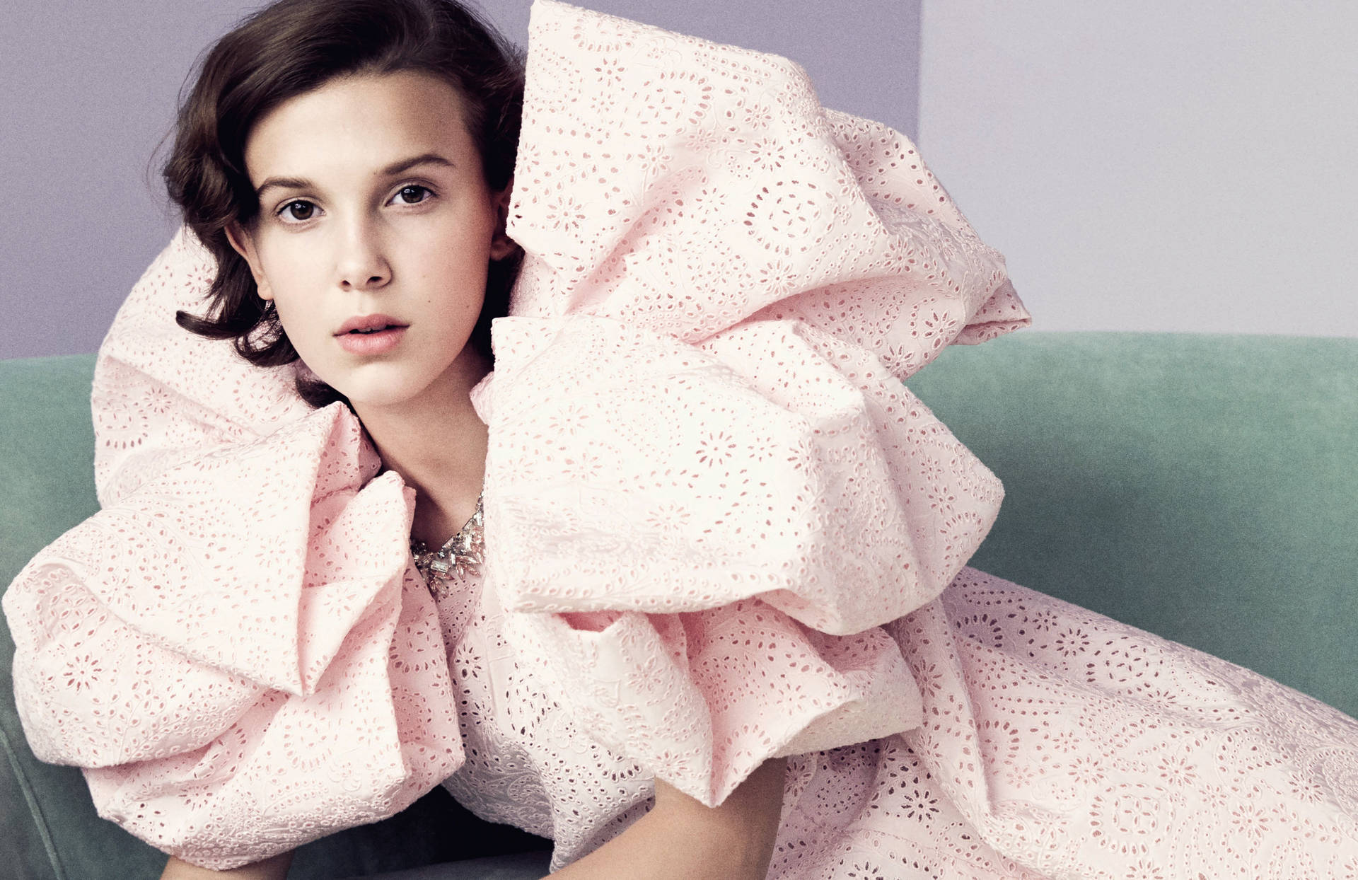 Millie Bobby Brown wearing statement puffed sleeves on the red carpet Wallpaper