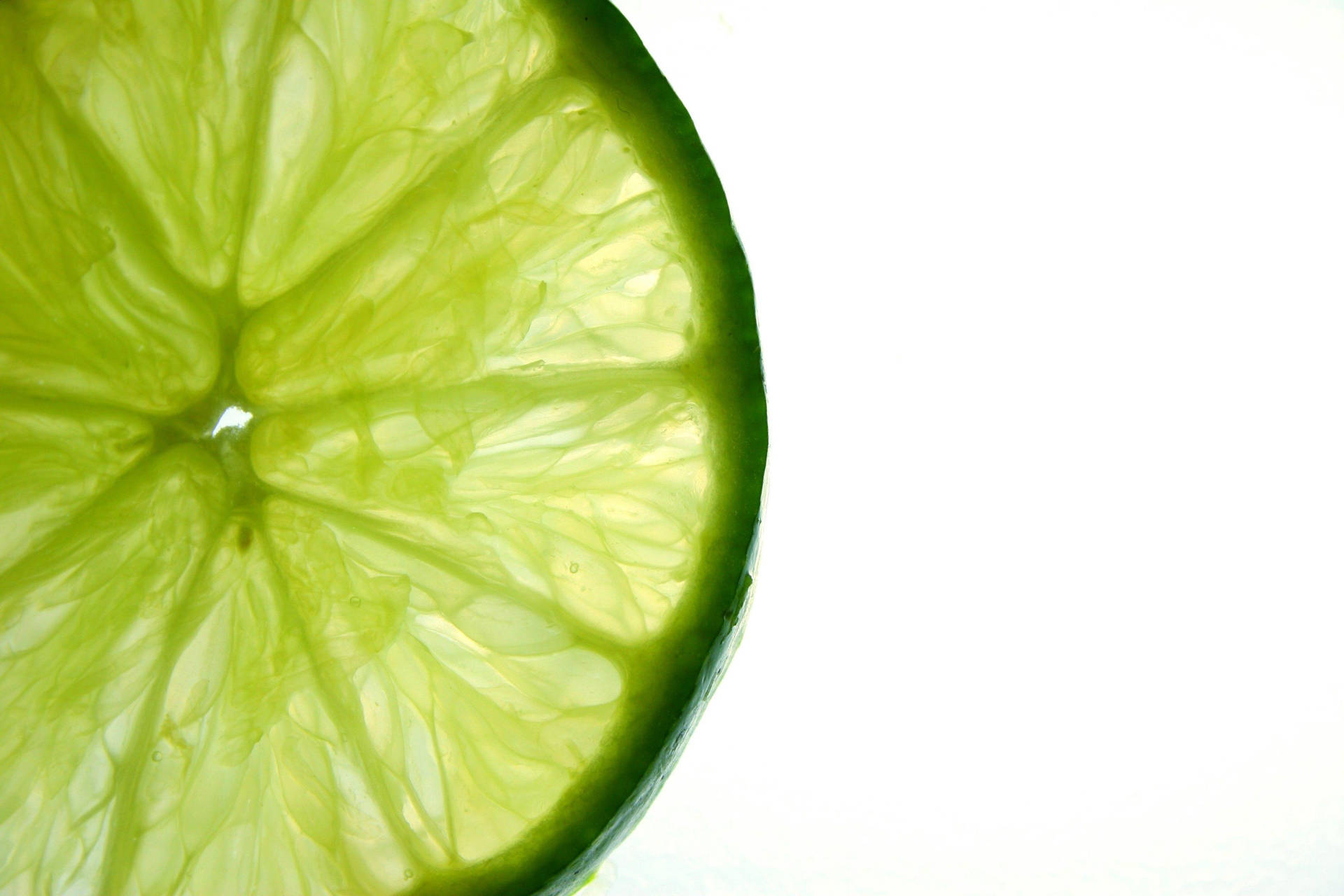 Pulveraktigttunt Skivat Grönt Lime-citrus På Datorskärmen/mobilskärmen. Wallpaper