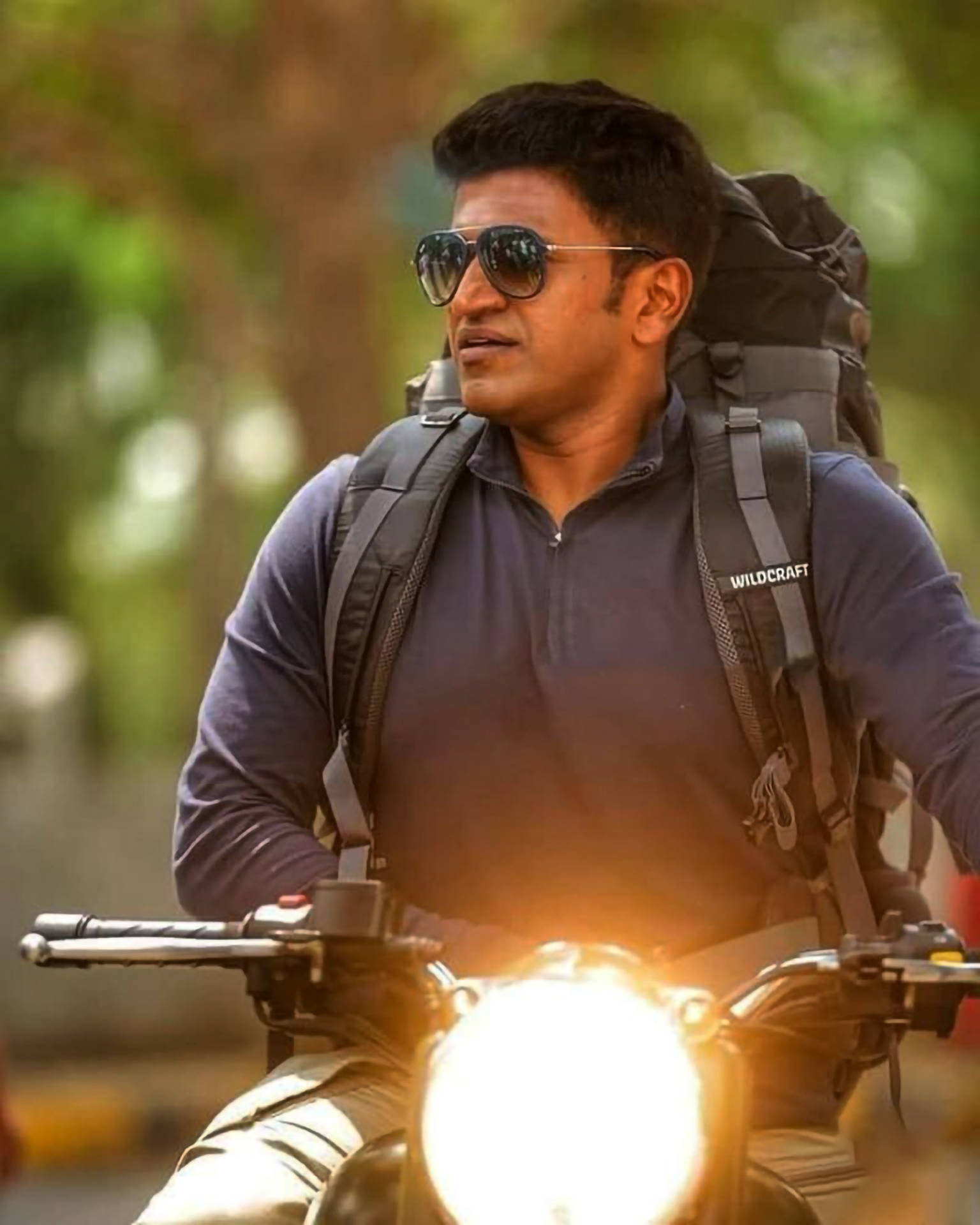 Puneeth Rajkumar Riding Motorcycle Wallpaper