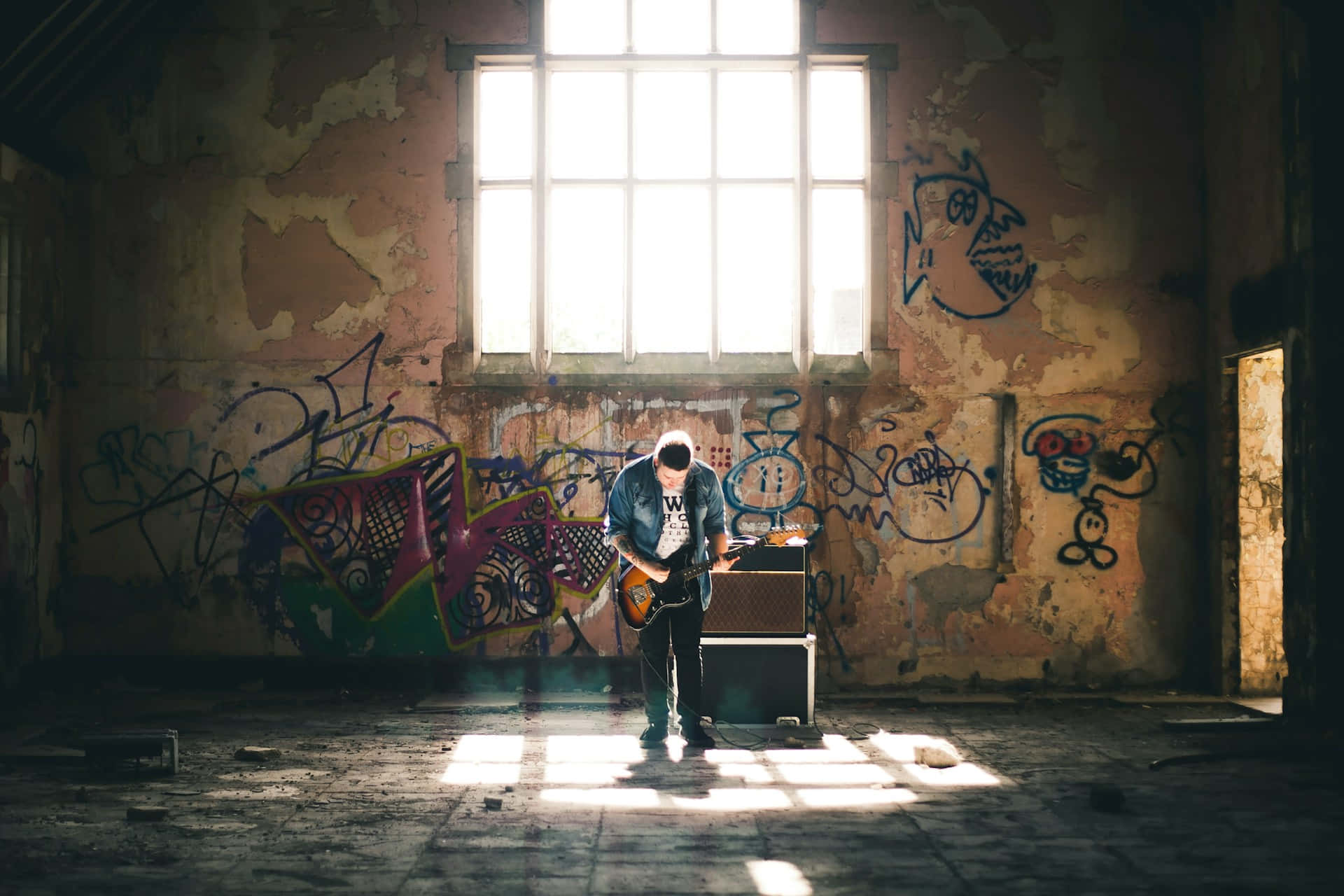 Punk Guitarist In Abandoned Building.jpg Wallpaper