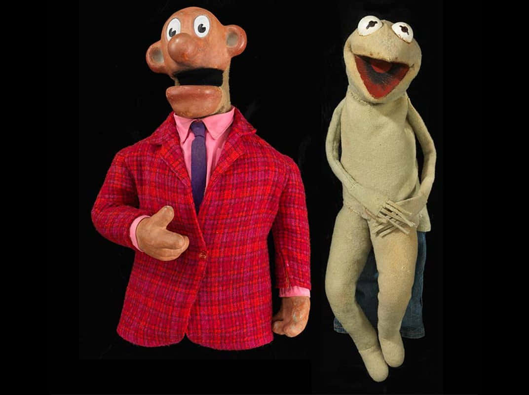 Two Puppets Of A Man And A Frog