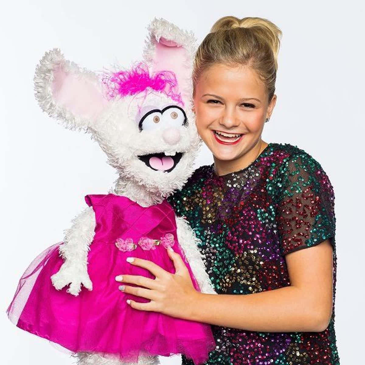 A Girl In A Pink Dress Holding A Stuffed Animal