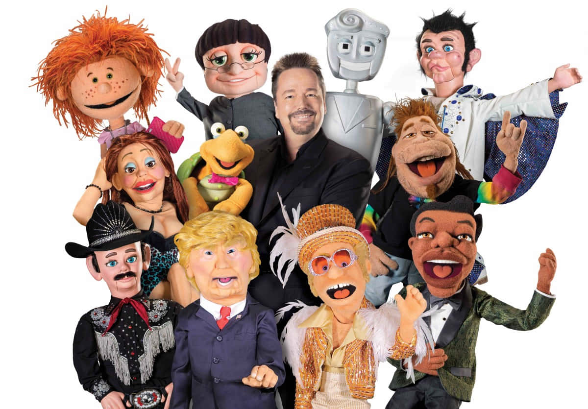 A Group Of Puppets With A Man In The Middle