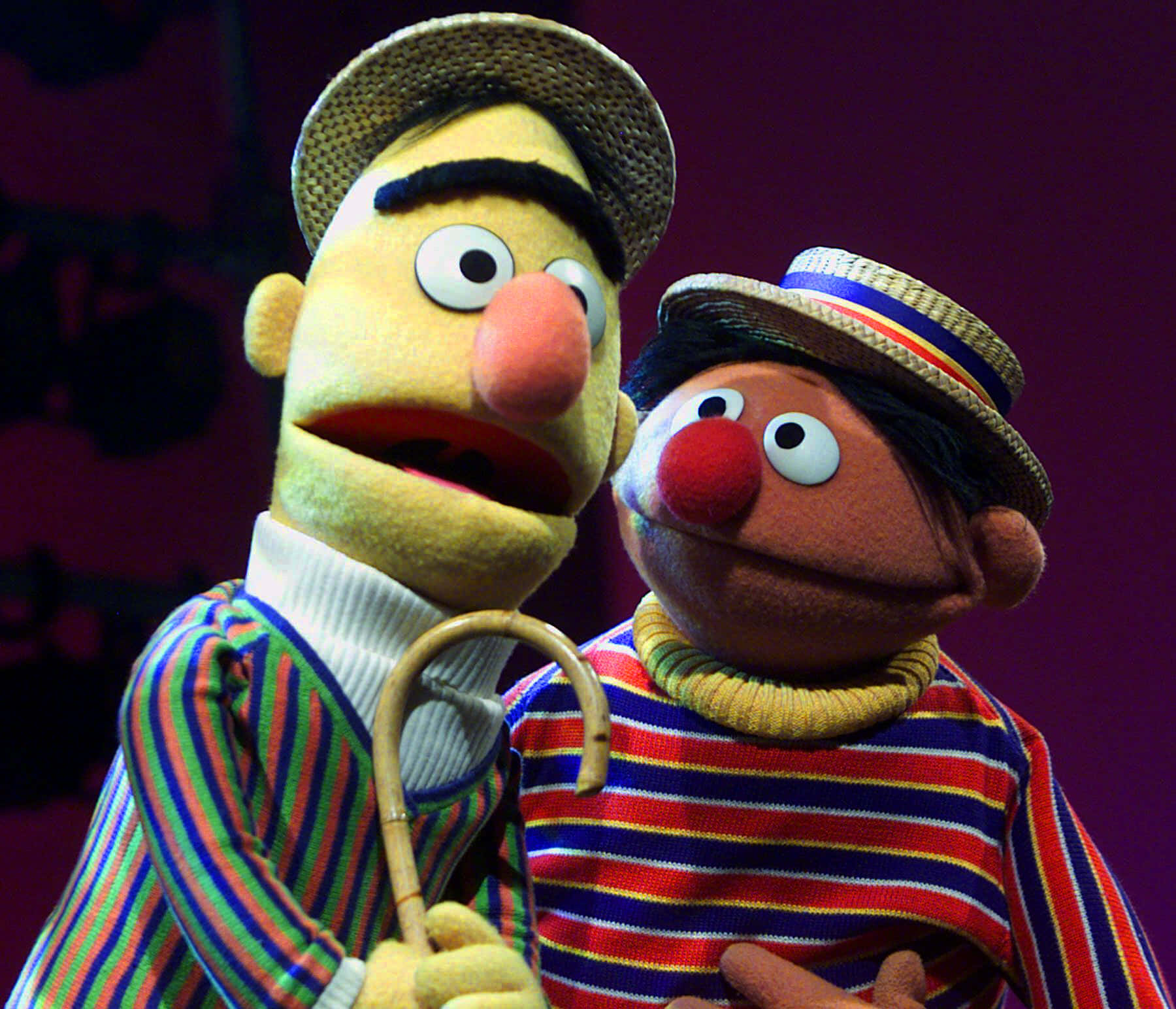 Two Puppets Dressed As The Muppets Stand Next To Each Other