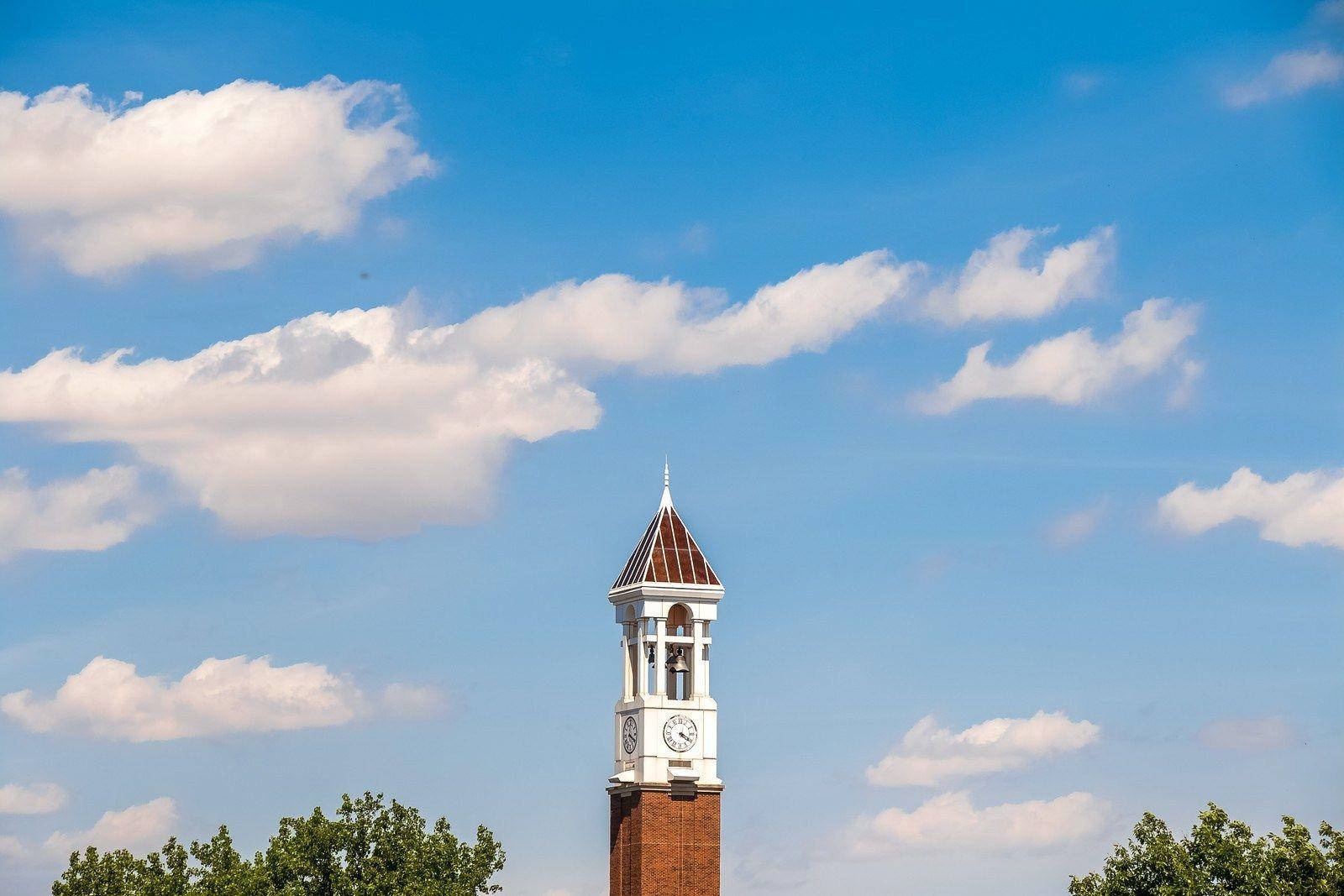 Purdue University Bell Tower Under Cloudy Sky Wallpaper