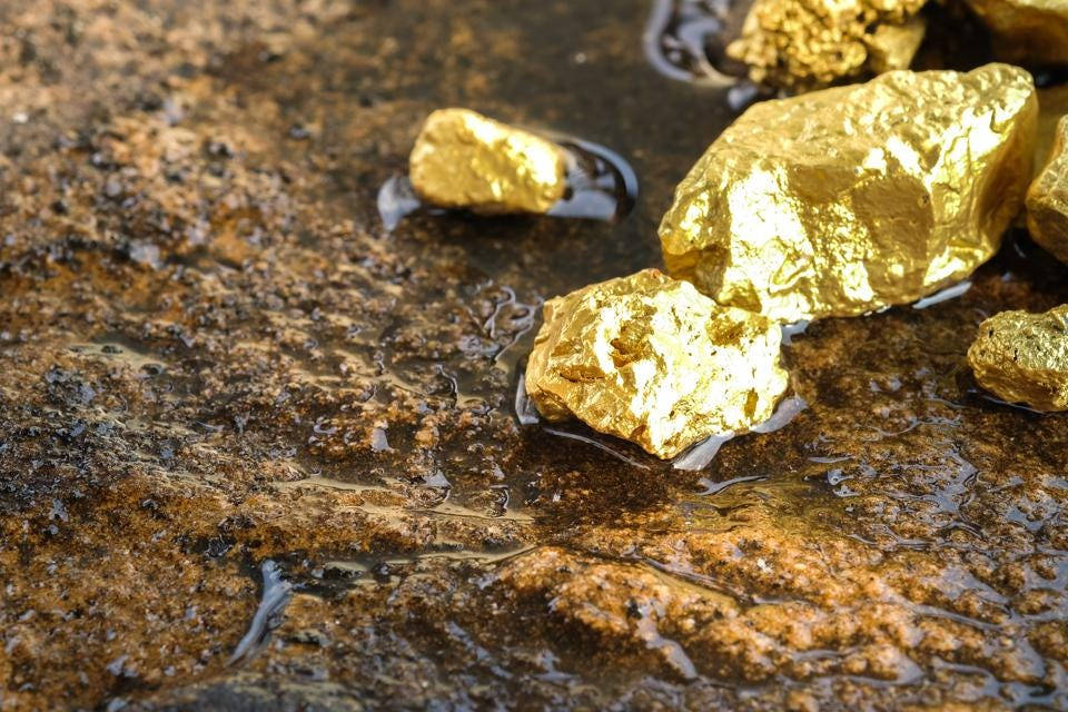 Pure Gold Nuggets On The Wet Ground Wallpaper