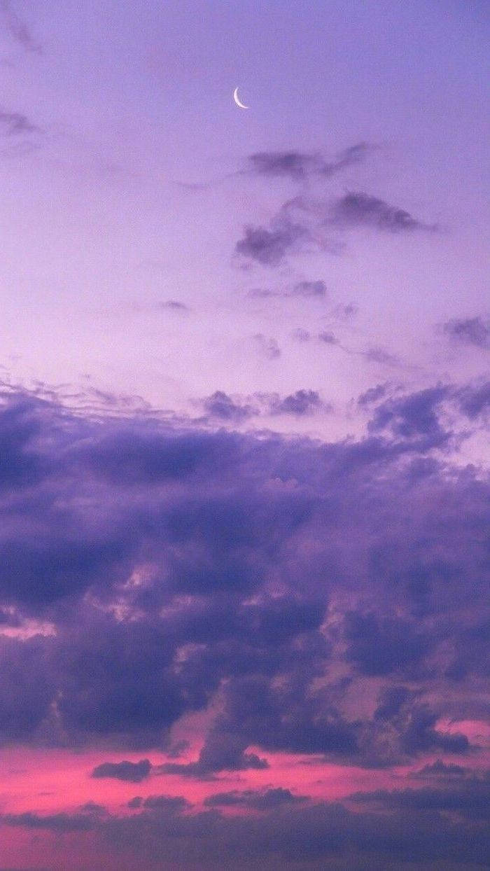 A Purple Sky With A Crescent And Clouds Wallpaper