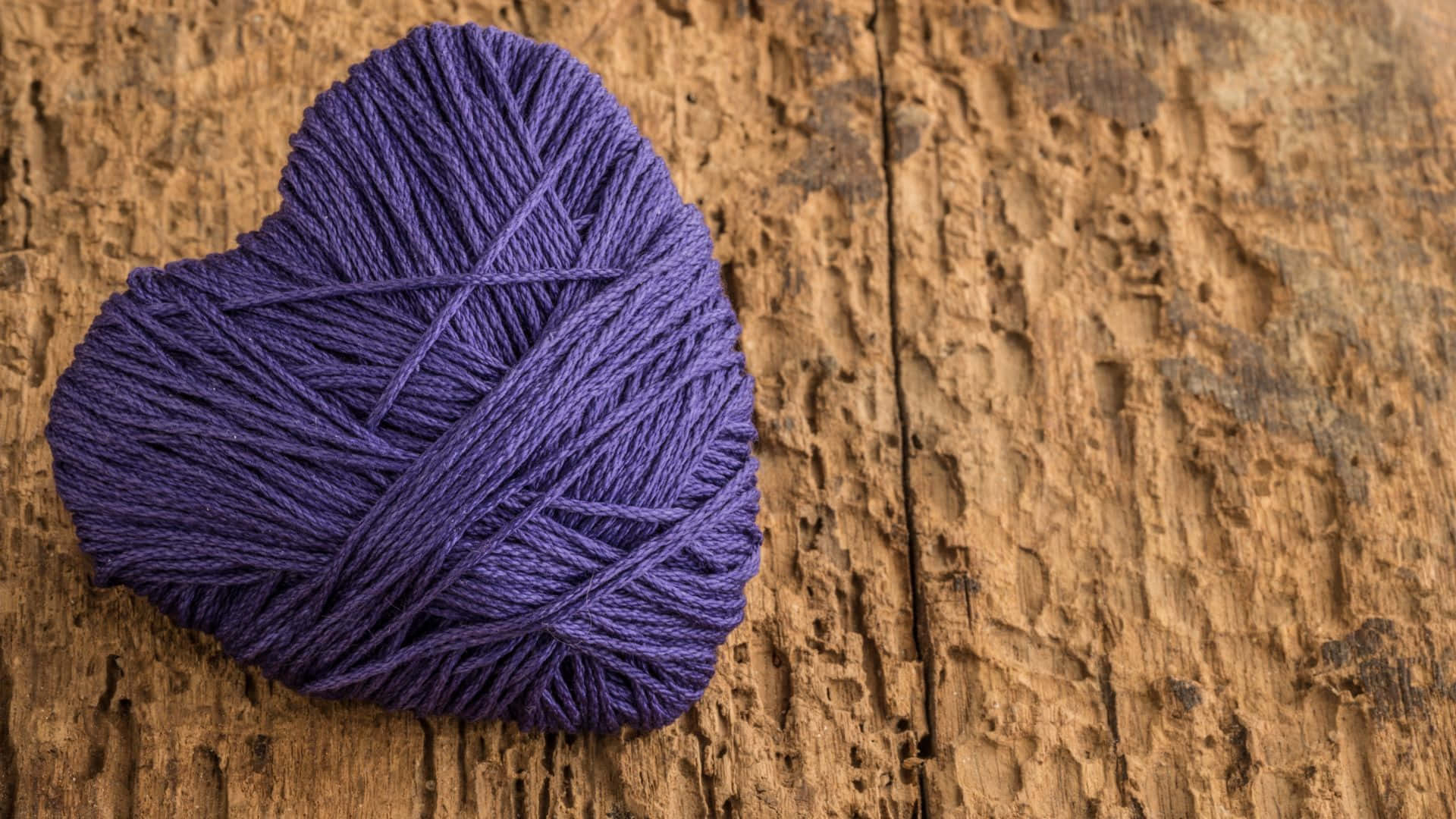 Purple Yarn On Wooden Background