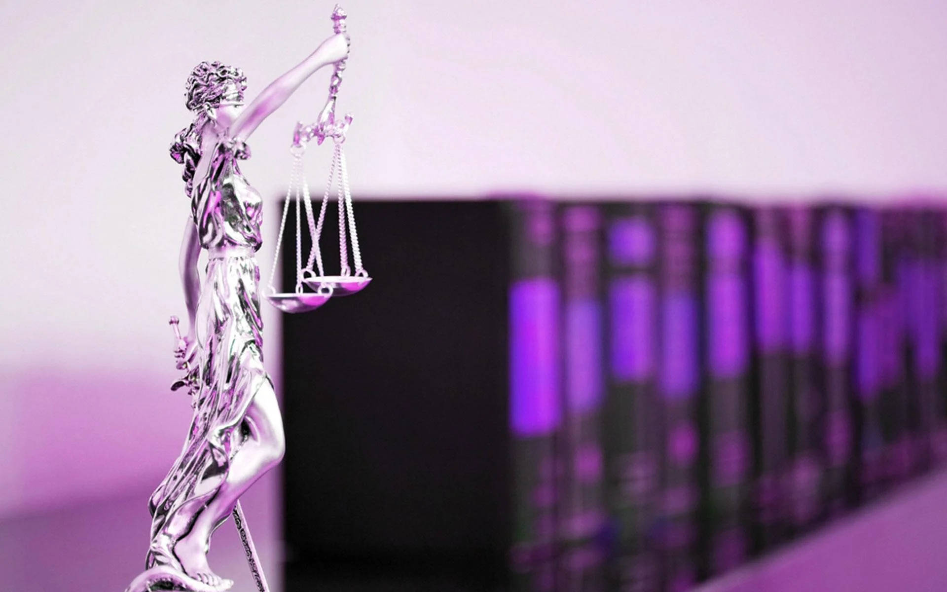 Justice in Action - Female Lawyer with Legal Books and Lady Justice Statue Wallpaper