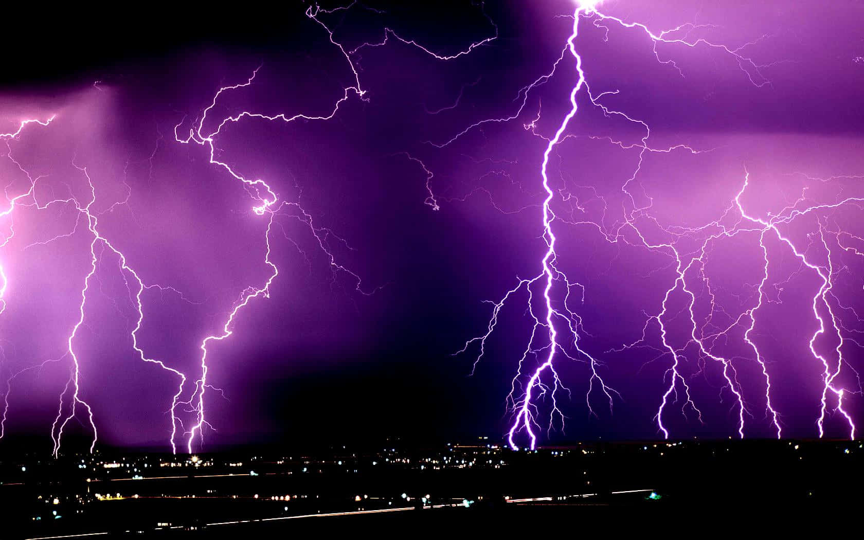Striking Purple Lightning in Night Sky