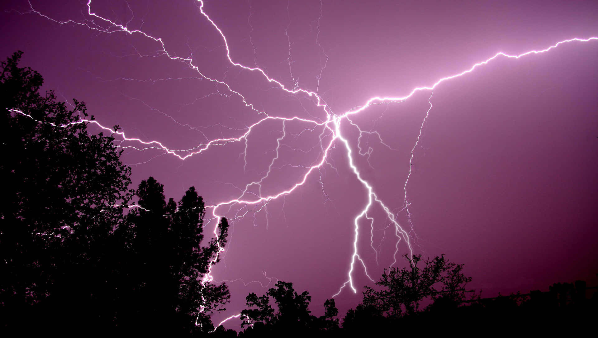 Purple Lightning Bolts Flashing In Sky Wallpaper