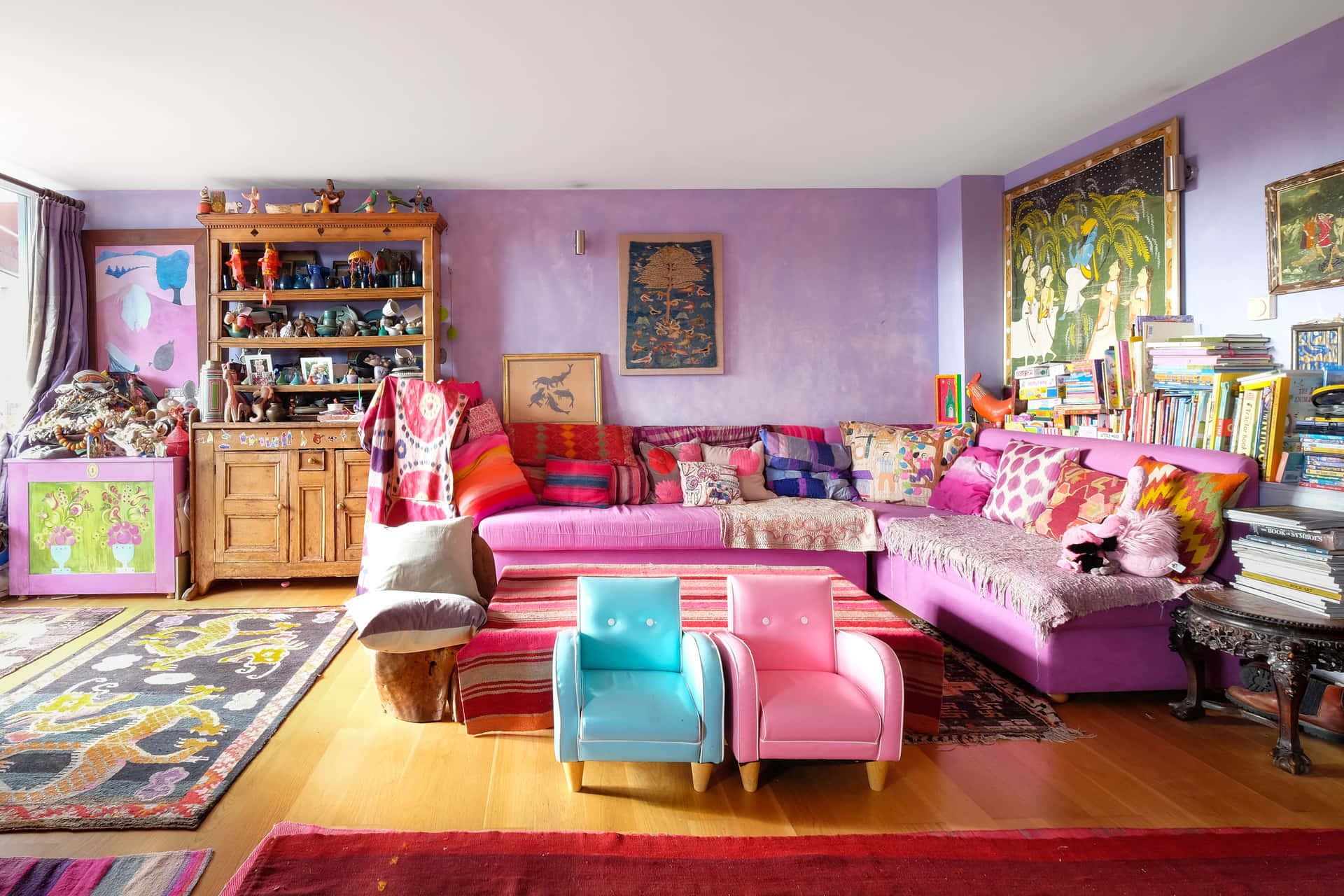 A Living Room With A Colorful Rug And A Colorful Couch