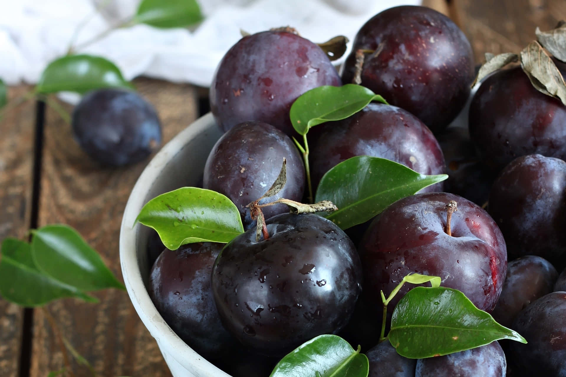 Bountiful Harvest of Delicious Purple Plums Wallpaper