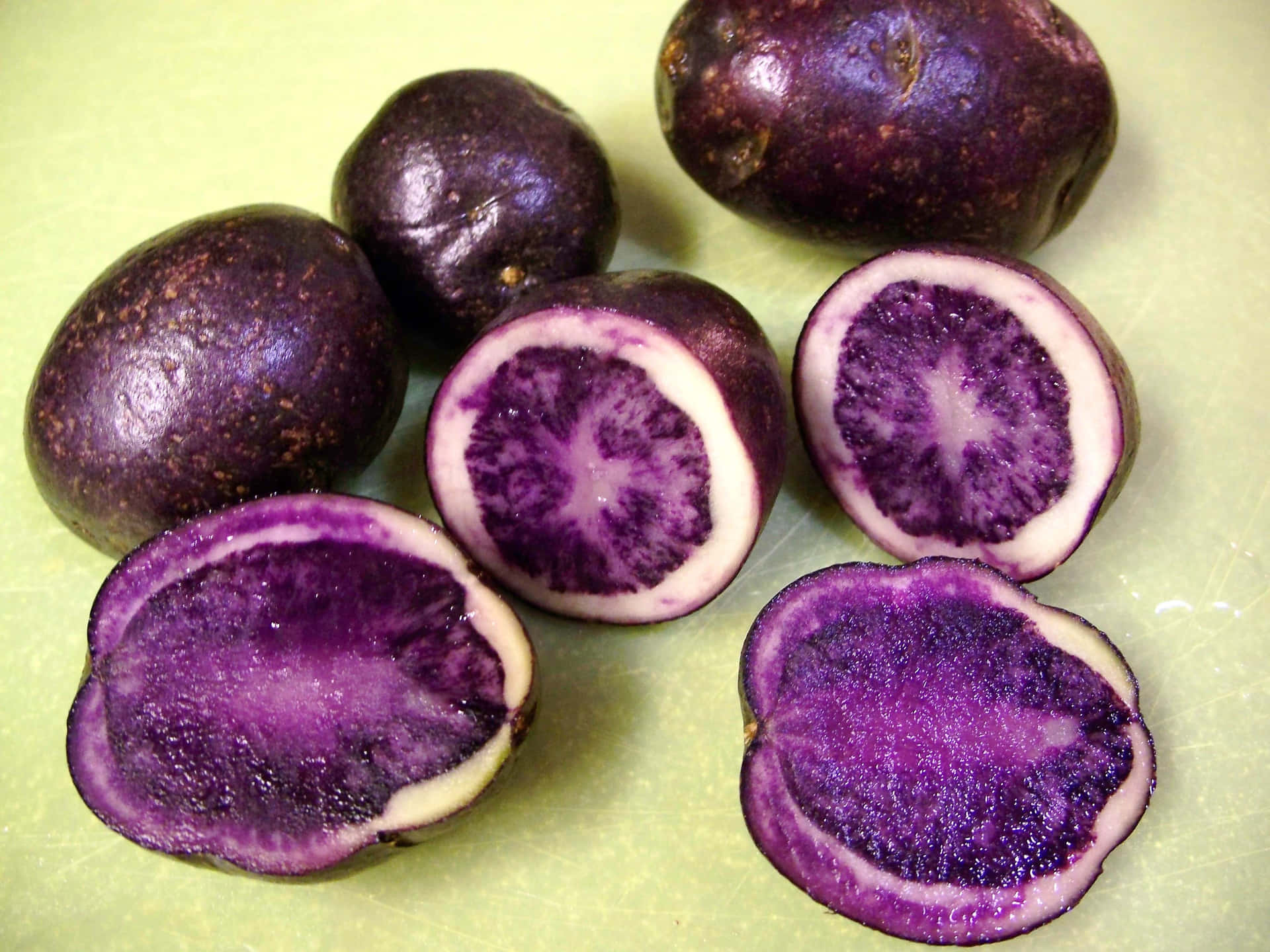 Enjoying a Freshly Harvested Purple Potato Wallpaper