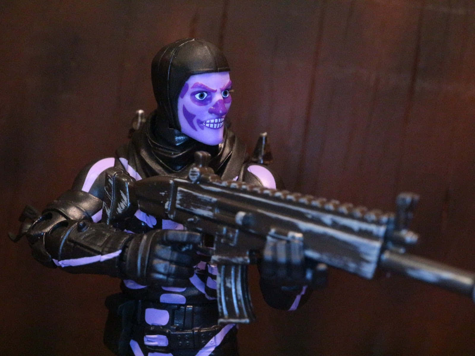 A Purple And Black Action Figure With A Gun Wallpaper