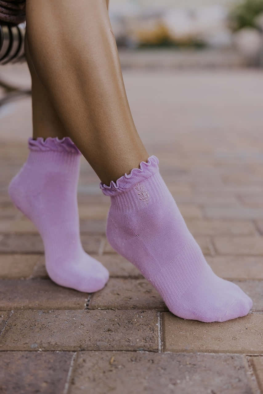 Keep active and stylish with these cozy purple socks Wallpaper