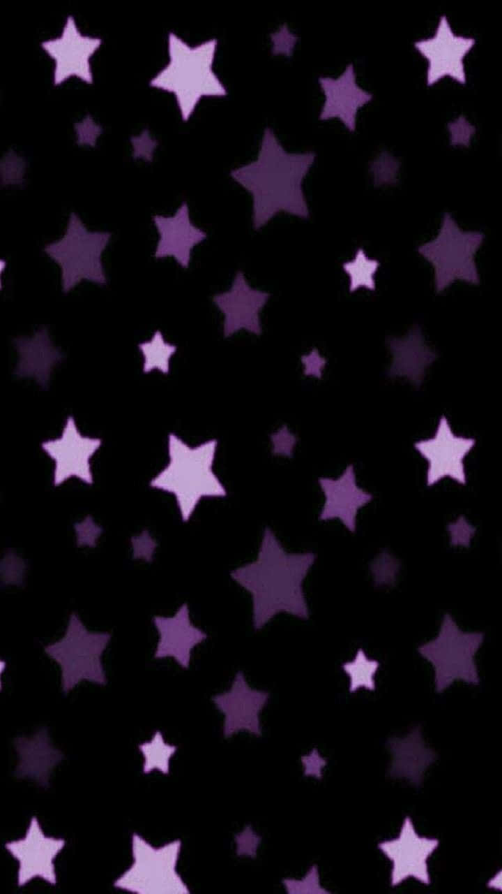 A brilliant five-pointed Purple Star surrounded by glimmering sparkles Wallpaper