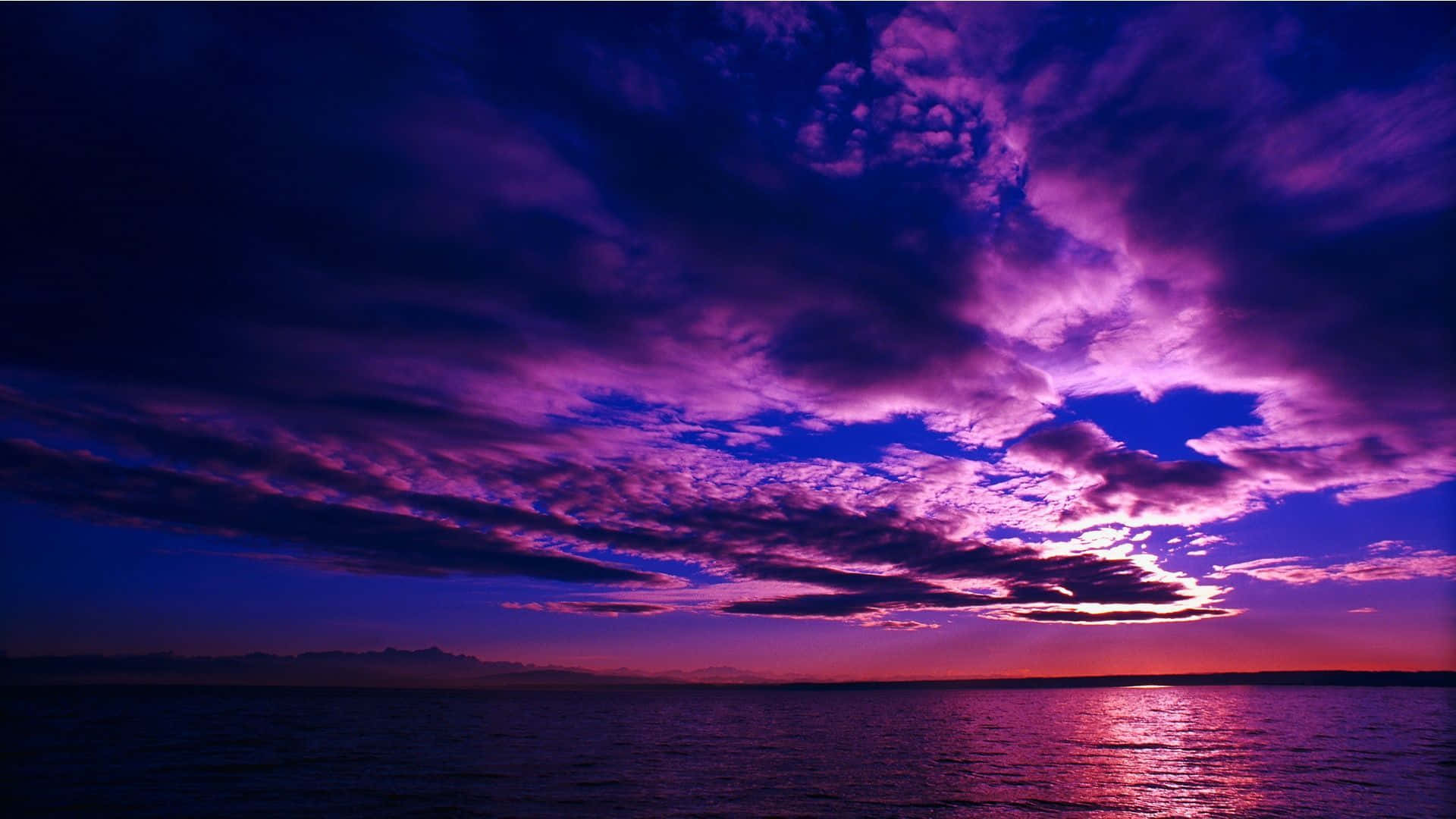 Majestic Purple Sunset over Scenic Landscape Wallpaper