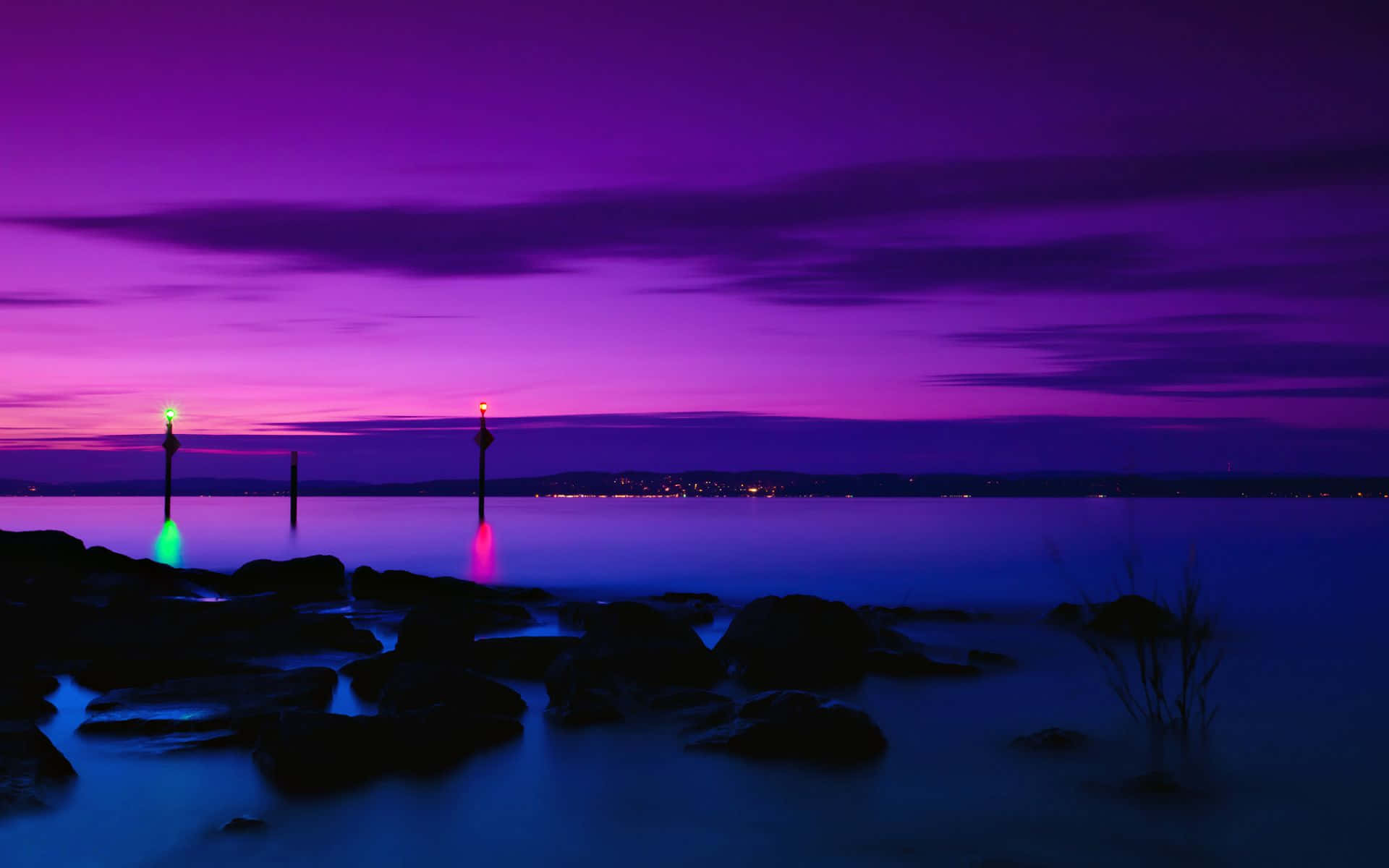 Purple Sunset Hues Over Tranquil Shore Wallpaper