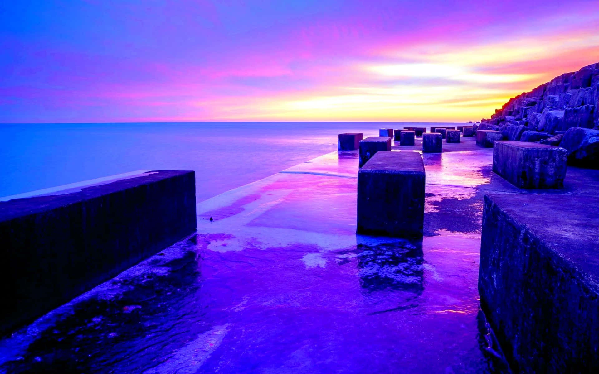 A breathtaking purple sunset at the beach Wallpaper