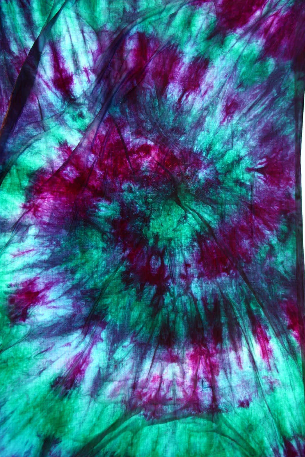 "Create colour patterns that dazzle with purple tie dye." Wallpaper