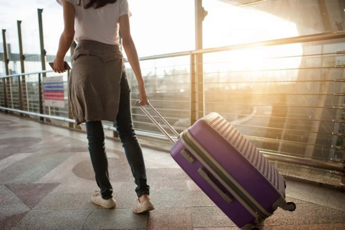 Brighten Your Vacation With A Trendy Purple Travel Bag Wallpaper