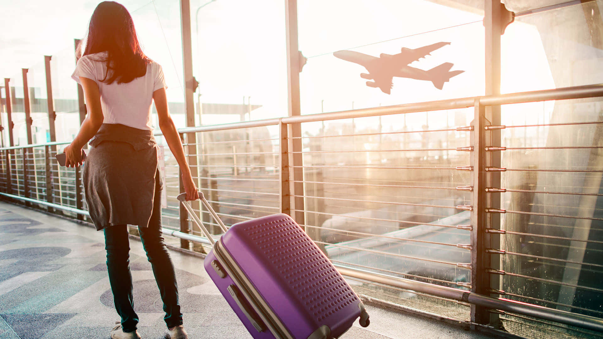 Take your travels to a new level with this stylish purple travel bag Wallpaper