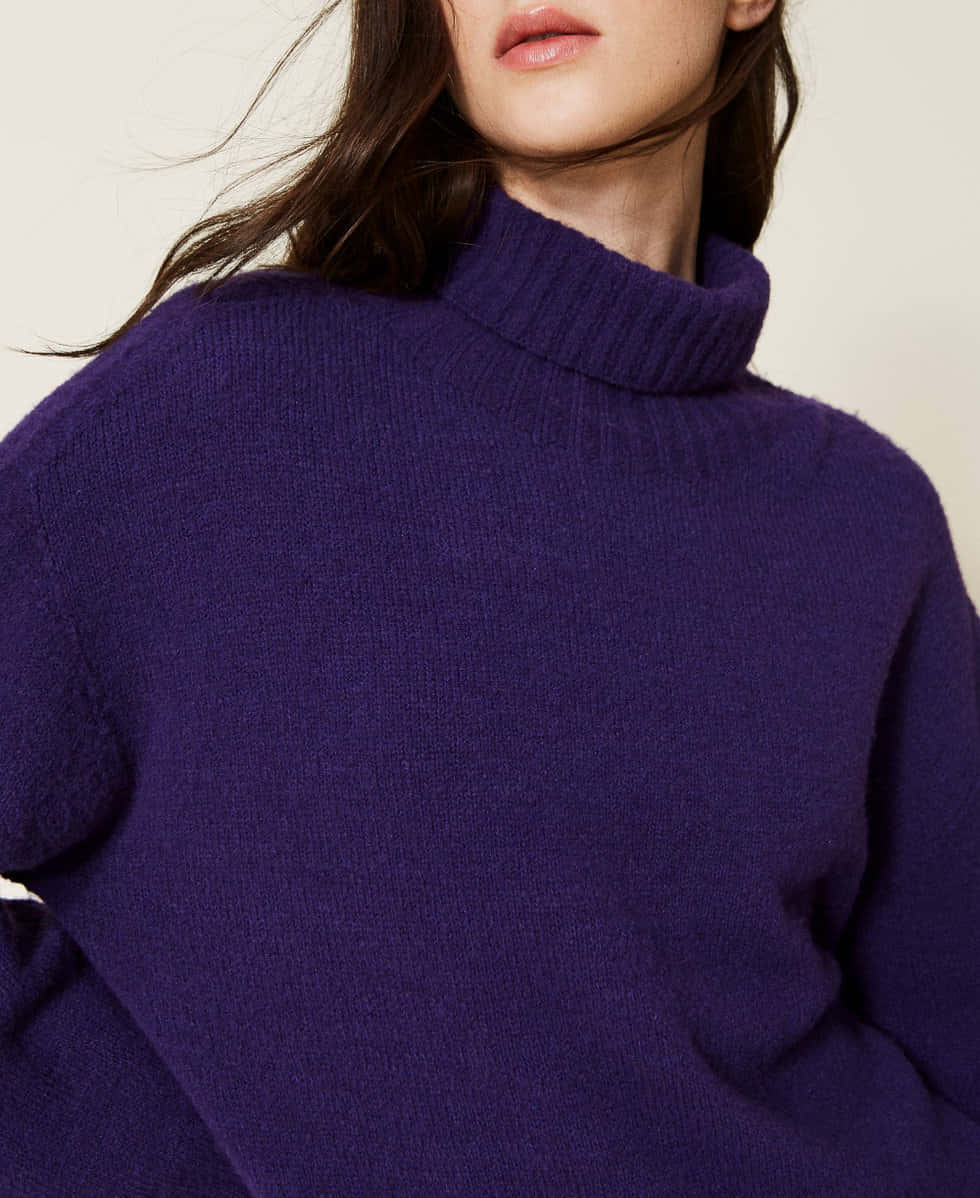 Stay warm and stylish this winter with a purple turtleneck sweater Wallpaper