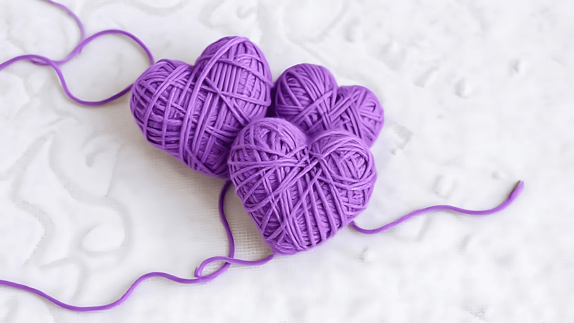 Purple Yarn Heart On White Fabric Background Wallpaper