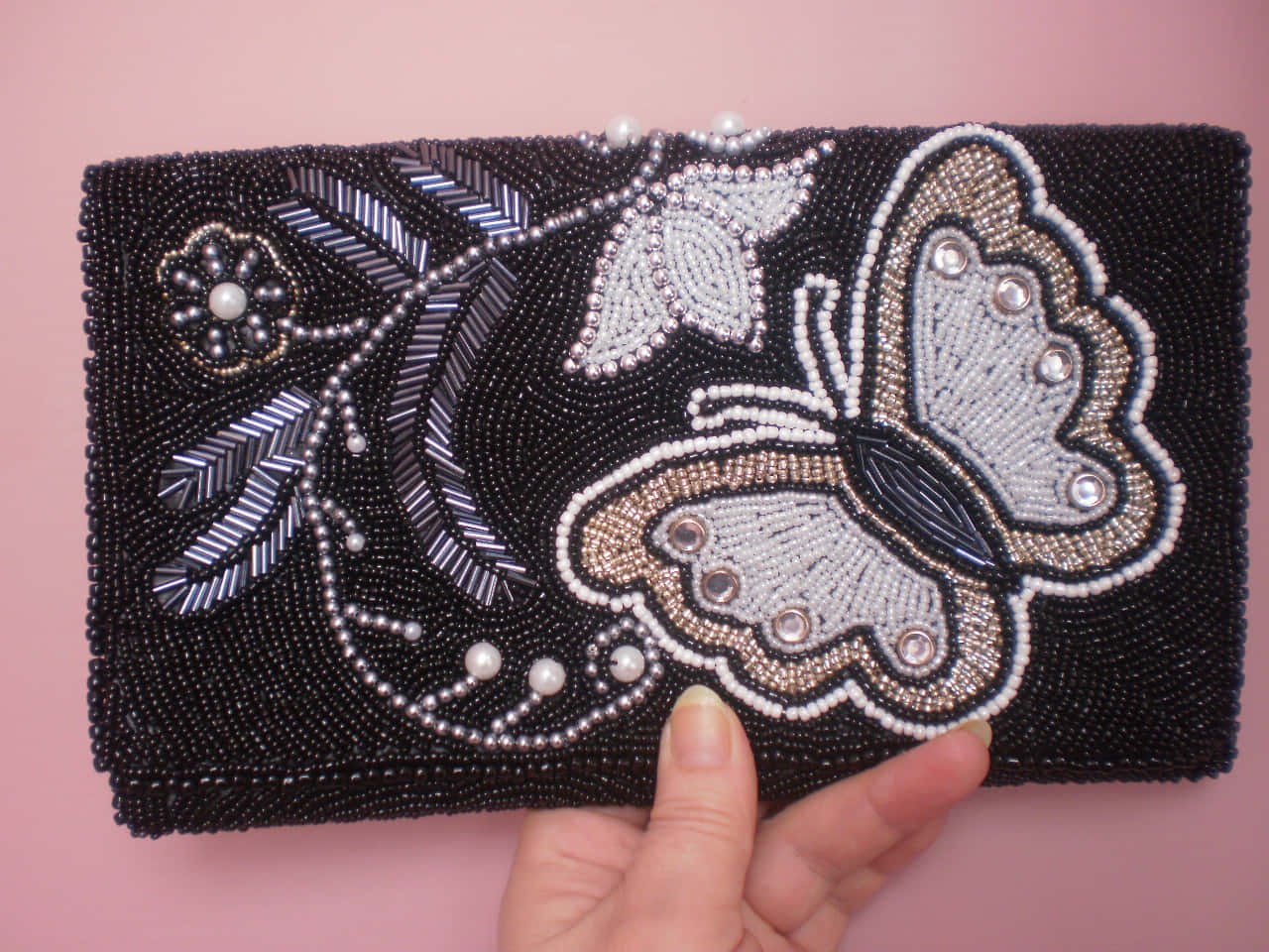A Black Clutch With A Butterfly On It