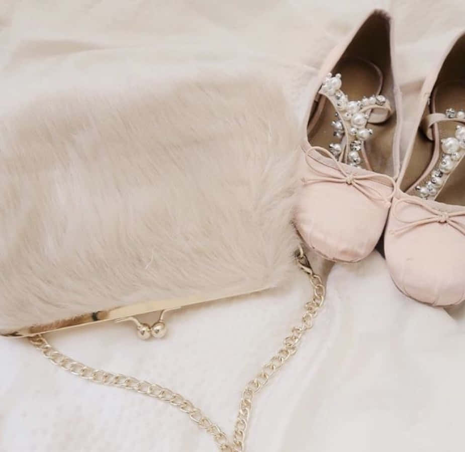 A Pair Of Pink Shoes And A Purse On A Bed